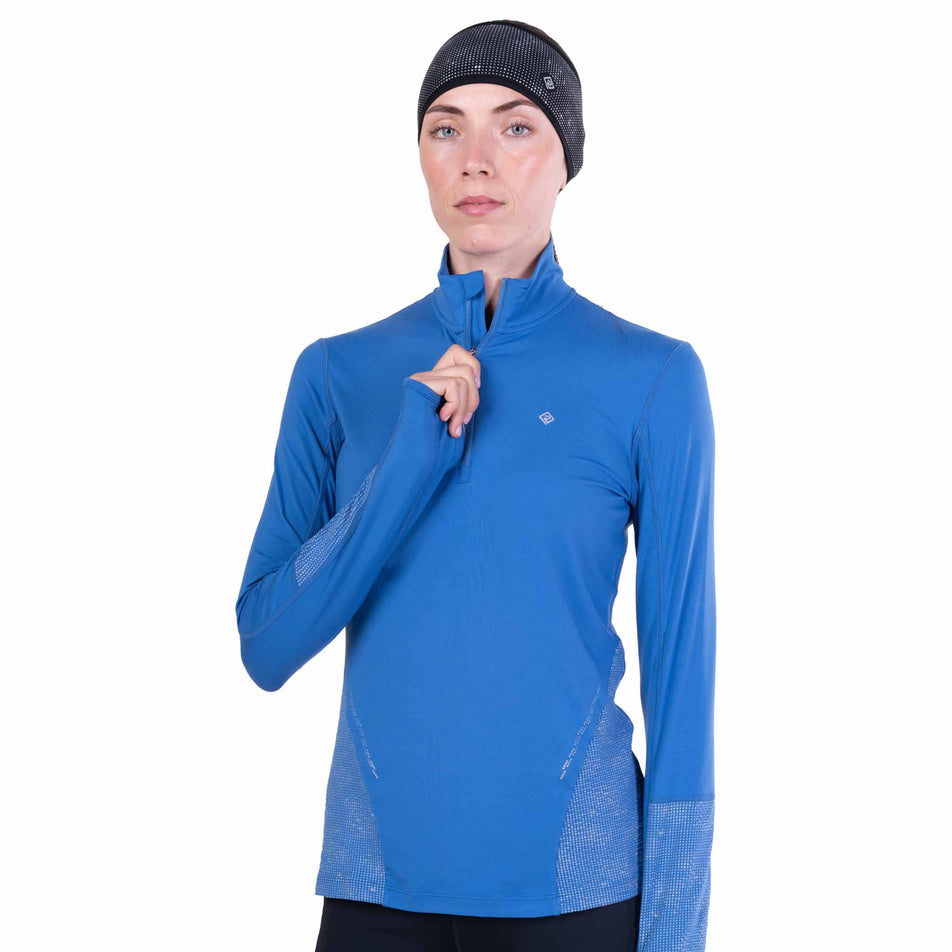 Front view of a model wearing the Ronhill Women's Tech Reflect 1/2 Zip in the Lumiere/Reflect colourway.