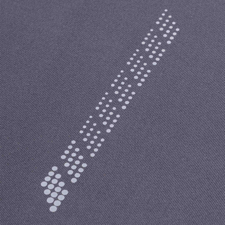 Close-up view of the reflective detail on the Ronhill Men's Tech Reflect 1/2 Zip in the Oxide/Reflect colourway.