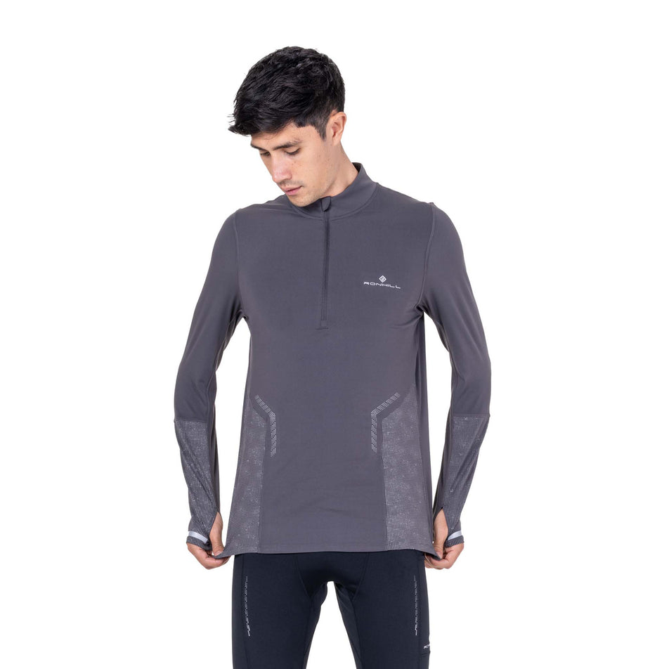 Front view of a model wearing the Ronhill Men's Tech Reflect 1/2 Zip in the Oxide/Reflect colourway.