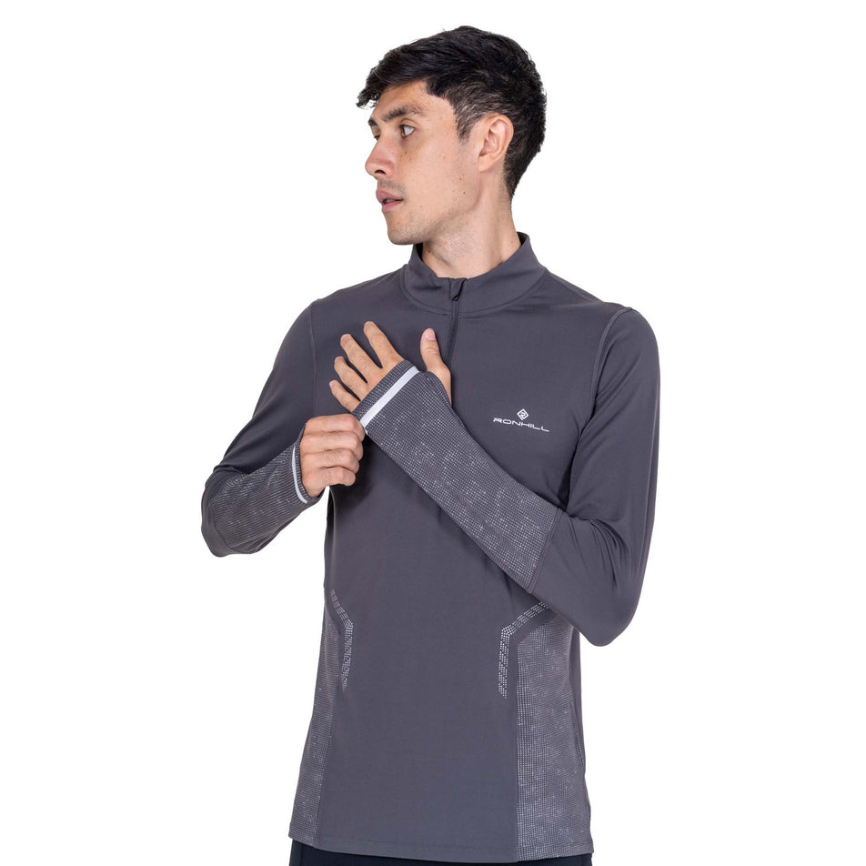 Front view of a model wearing the Ronhill Men's Tech Reflect 1/2 Zip in the Oxide/Reflect colourway.