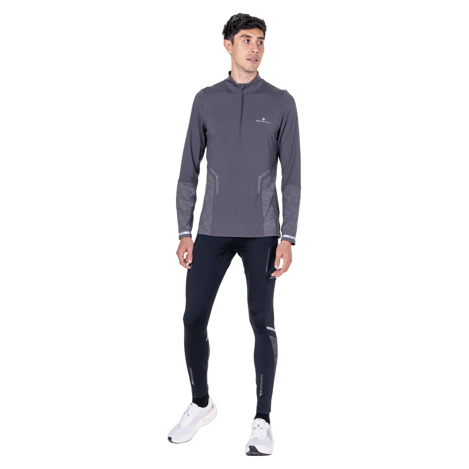 Front view of a model wearing the Ronhill Men's Tech Reflect 1/2 Zip in the Oxide/Reflect colourway.