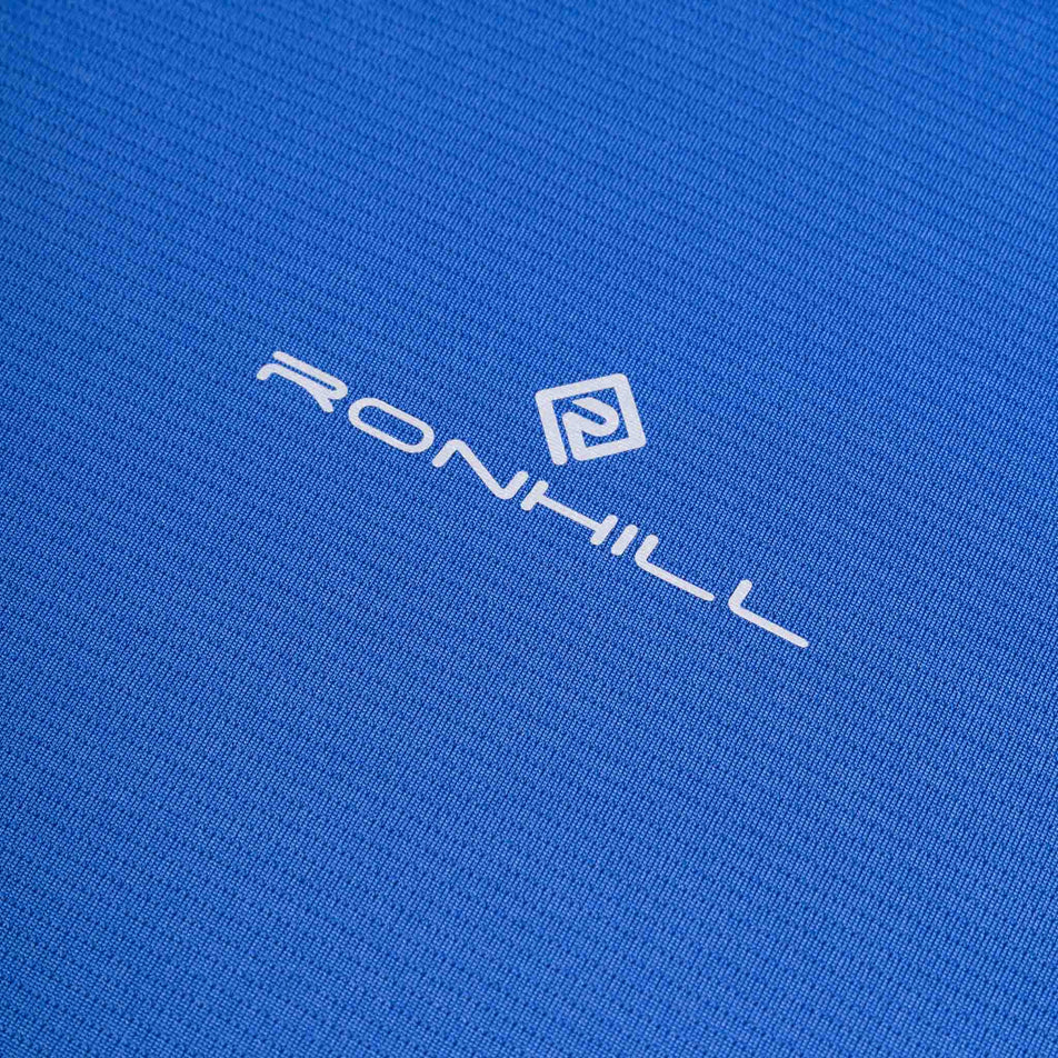 Close-up view of the Ronhill logo on the Ronhill Men's Core L/S Tee in the Dark Cobalt/Silver colourway.