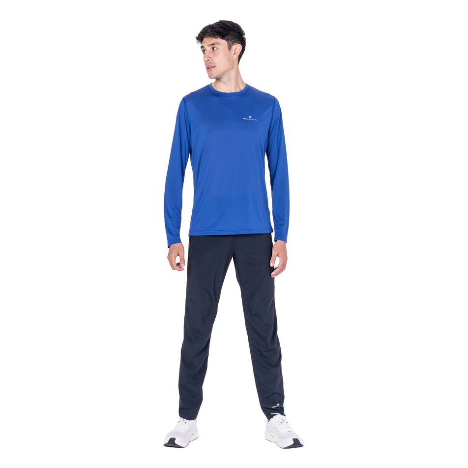 Front view of a model wearing the Ronhill Men's Core L/S Tee in the Dark Cobalt/Silver colourway.