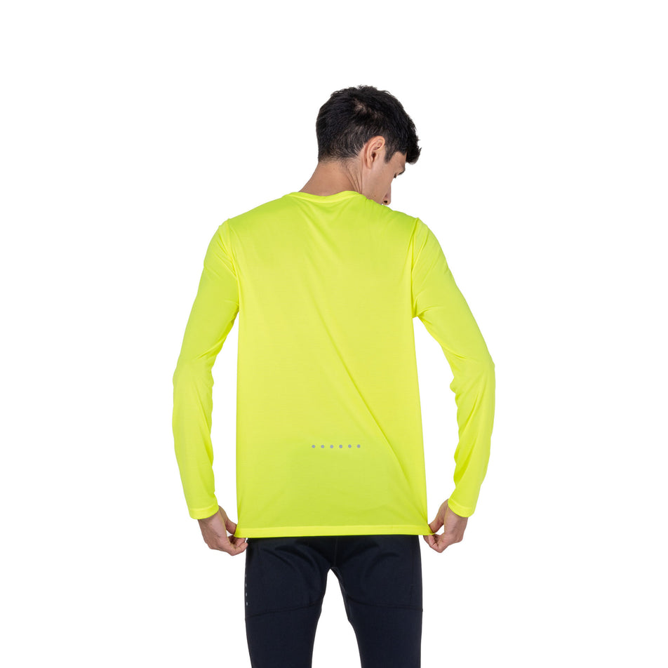 Back view of a model wearing the Ronhill Men's Core L/S Tee in the Fluo Zest colourway.