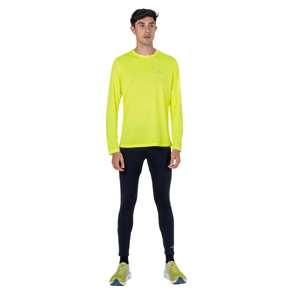 Front view of a model wearing the Ronhill Men's Core L/S Tee in the Fluo Zest colourway.