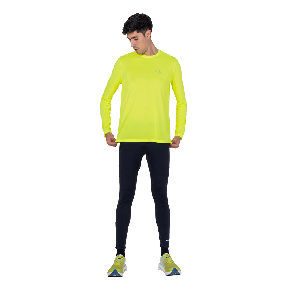 Front view of a model wearing the Ronhill Men's Core L/S Tee in the Fluo Zest colourway.