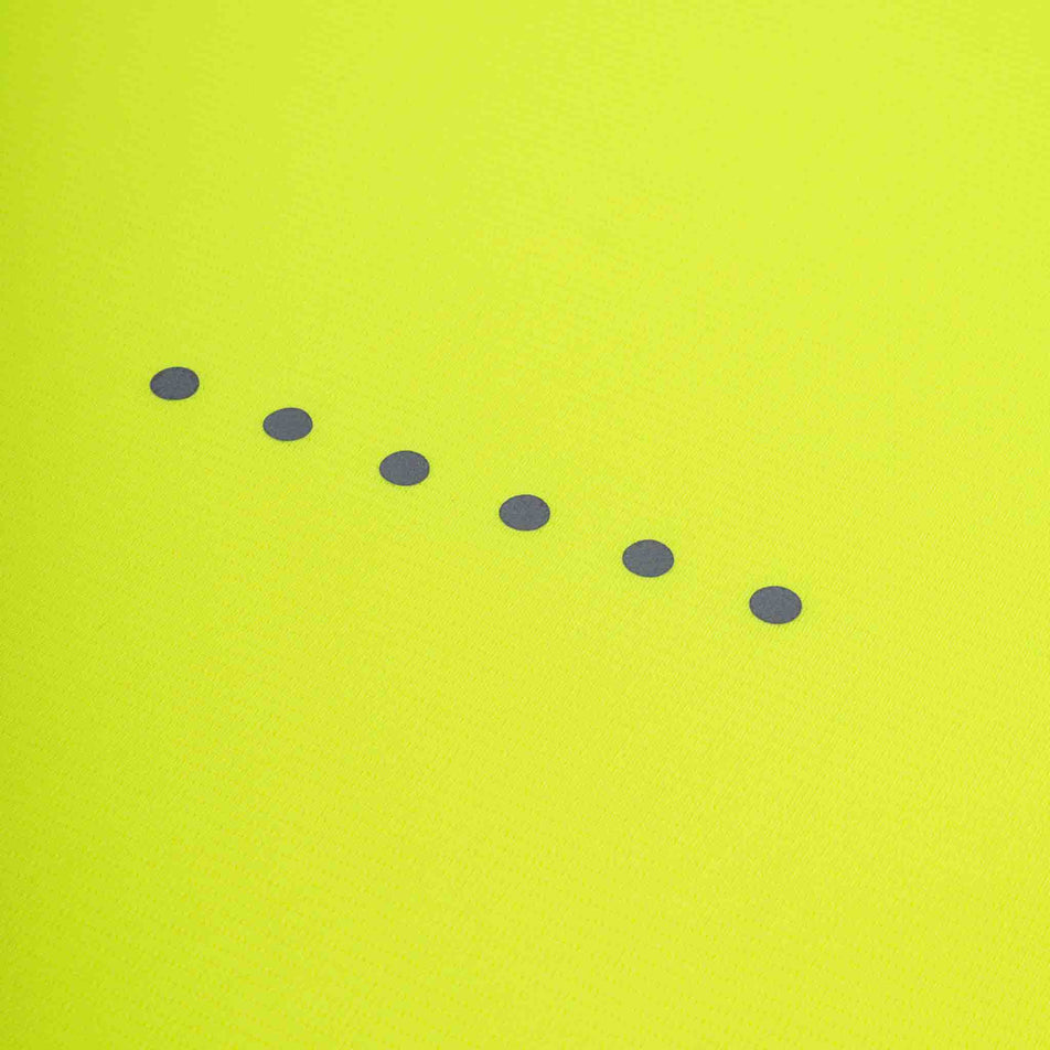 Close-up view of the reflective dots on the back of the Ronhill Men's Core L/S Tee in the Fluo Zest colourway.