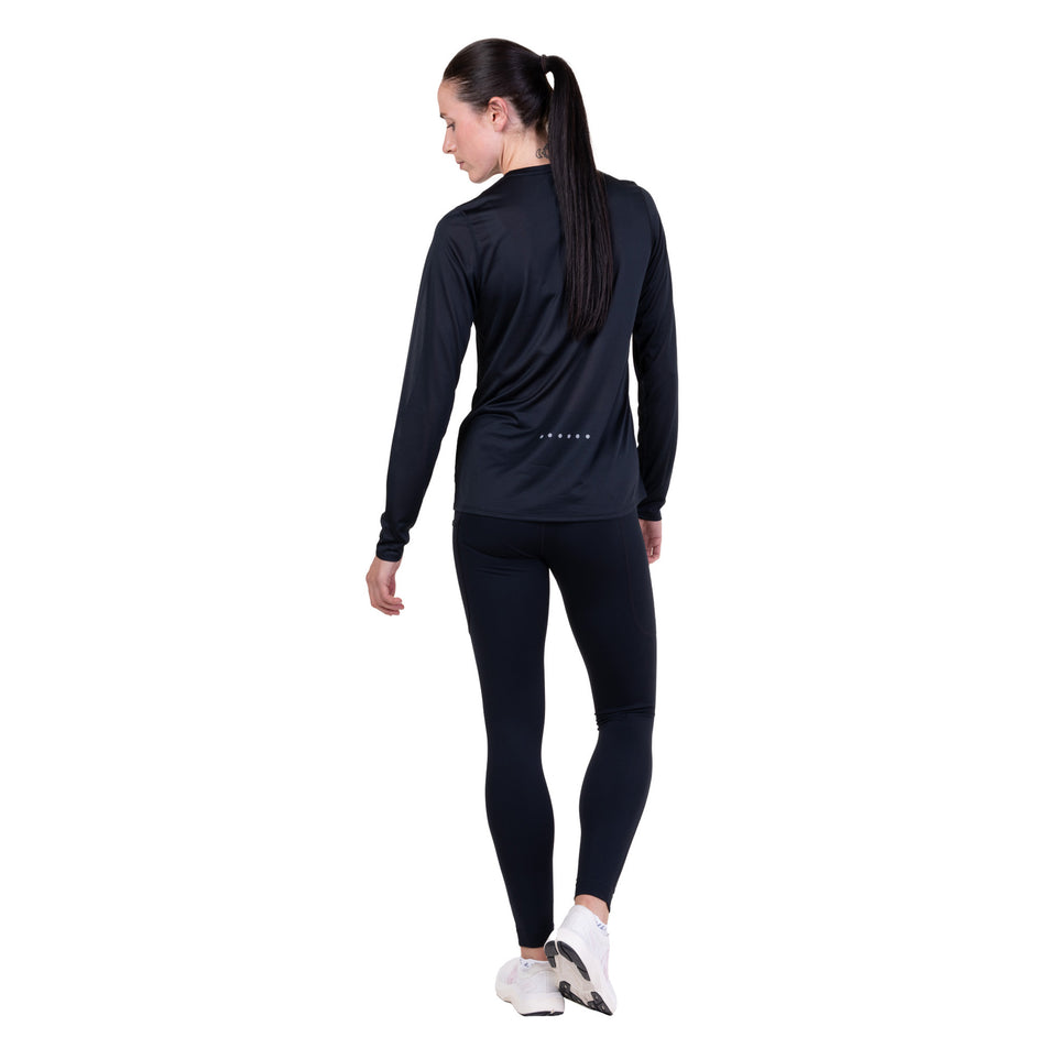 Back view of a model wearing the Ronhill Women's Core L/S Tee in the Black colourway.