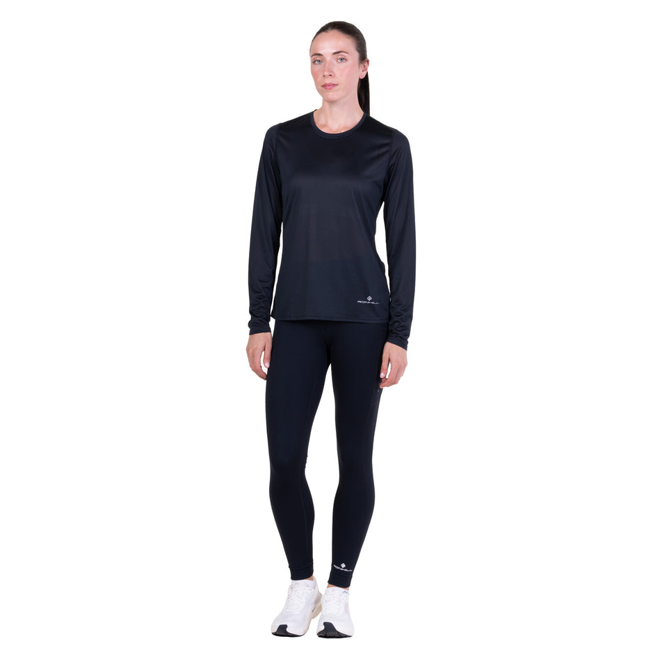 Front view of a model wearing the Ronhill Women's Core L/S Tee in the Black colourway.