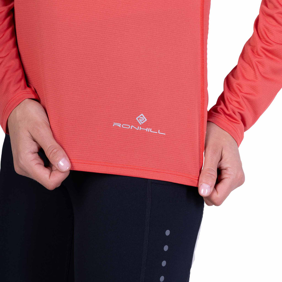 Close-up view of the Ronhill logo on the Ronhill Women's Core L/S Tee - Sumac/Blue Violet in the colourway.