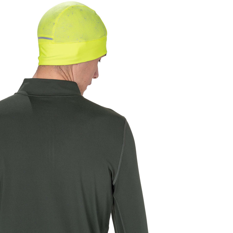 Back view of a model wearing the Ronhill Unisex Reflect Beanie in the Fluo Zest/Reflect colourway.