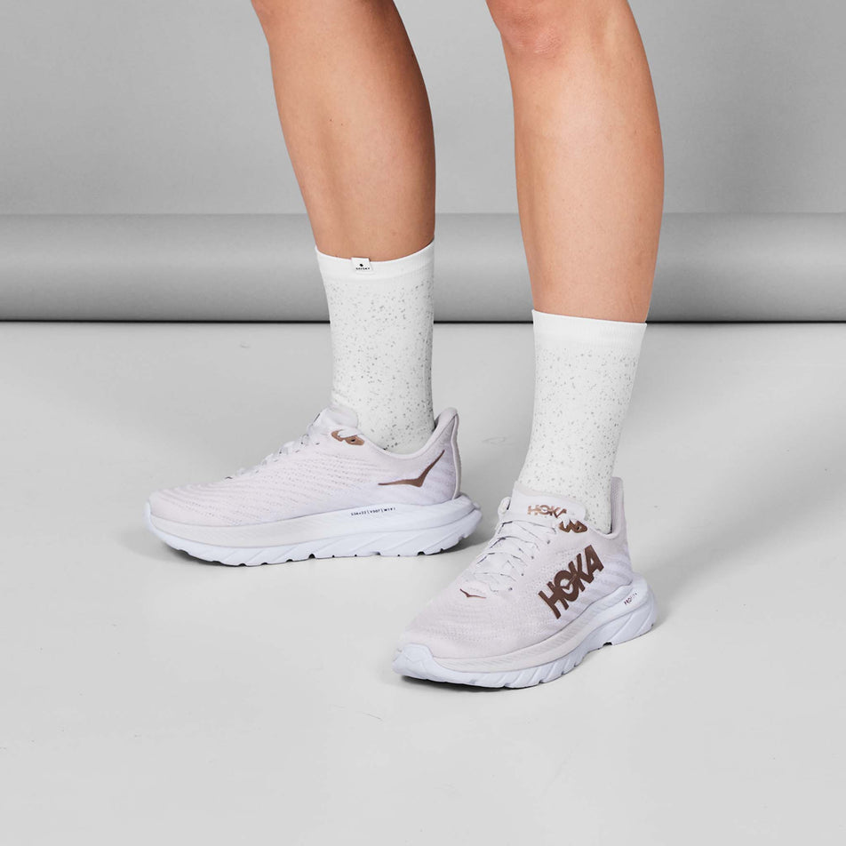 A model wearing a pair of SAYSKY Unisex Combat Reflective High Socks in the White colourway.