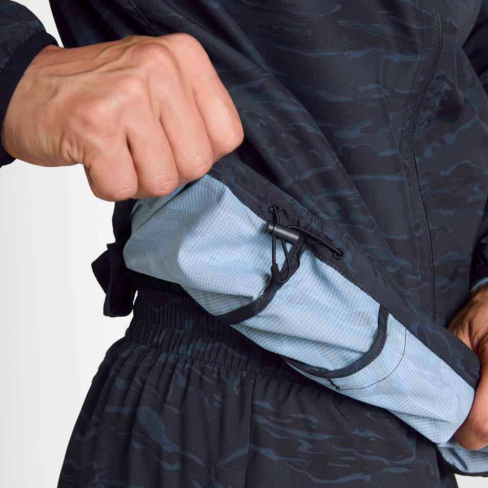 The adjustable waist cord of the SAYSKY Men's Tiger Pace Jacket in the Black Camo colourway.