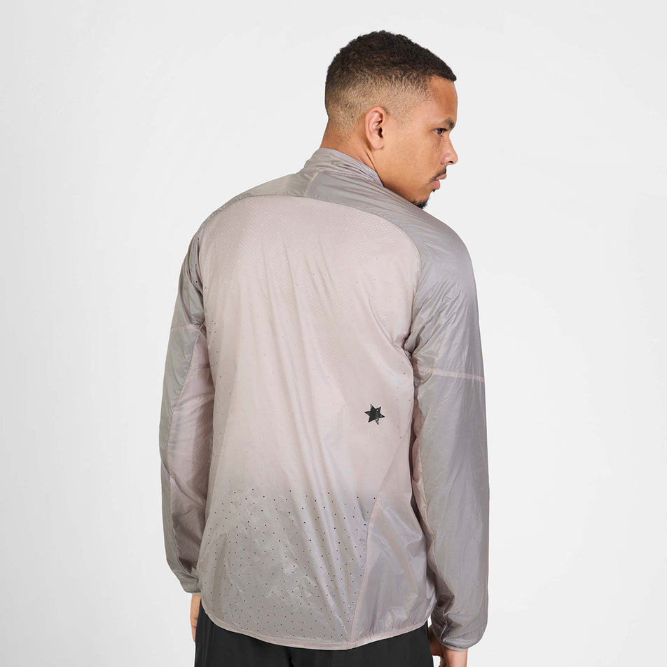 Back view of a model wearing the SAYSKY Men's Flow Thermo Jacket in the Beige colourway.