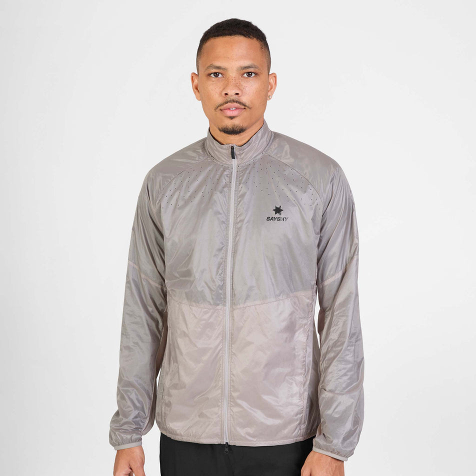 Front view of a model wearing the SAYSKY Men's Flow Thermo Jacket in the Beige colourway.