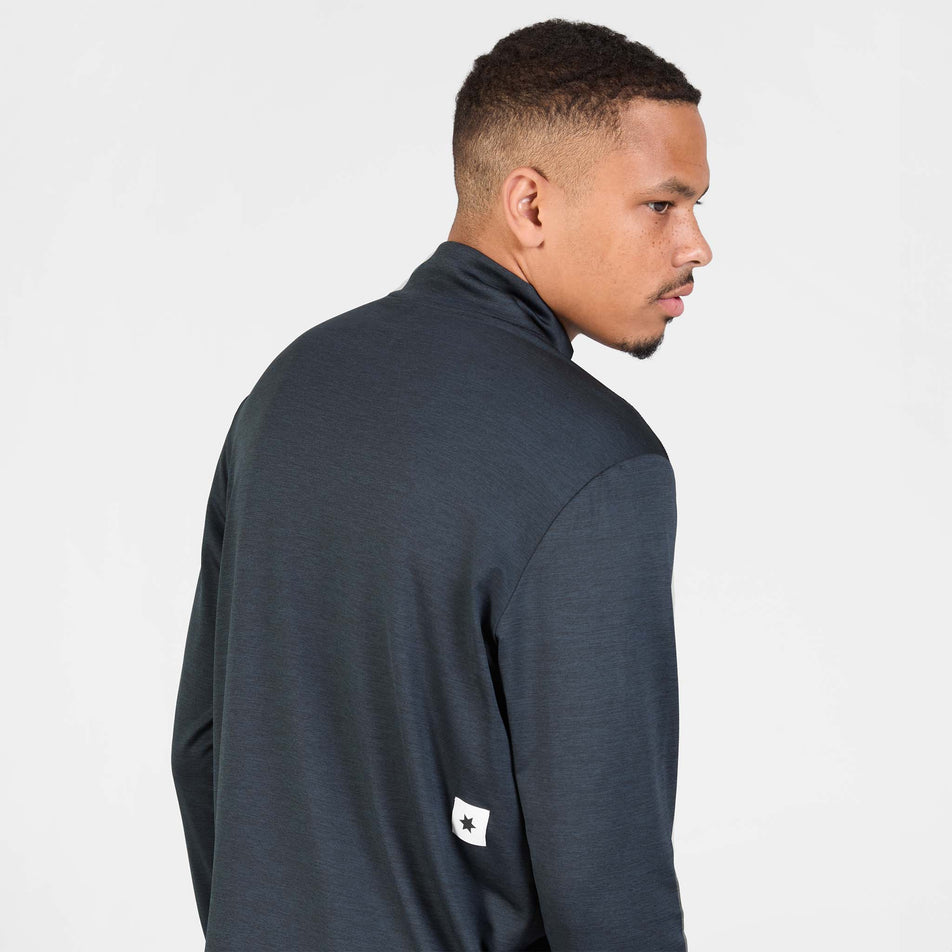 Back view of a model wearing the SAYSKY Men's Pace Half Zip Long Sleeve in the  Black colourway.