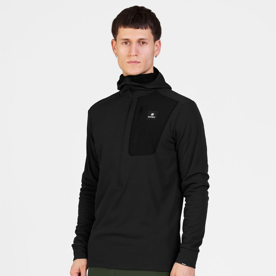 Front view of a model wearing the SAYSKY Men's Combat Half Zip Fleece Hoodie in the Black colourway.