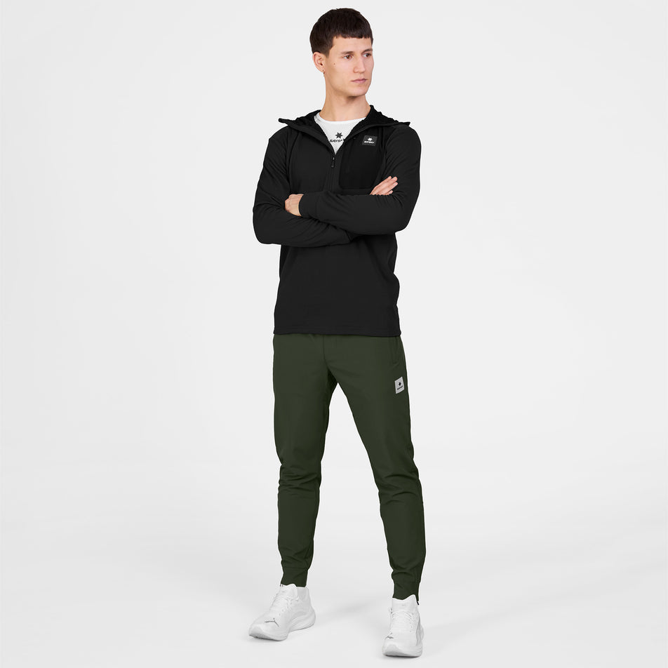 Front view of a model wearing the SAYSKY Men's Combat Half Zip Fleece Hoodie in the Black colourway.