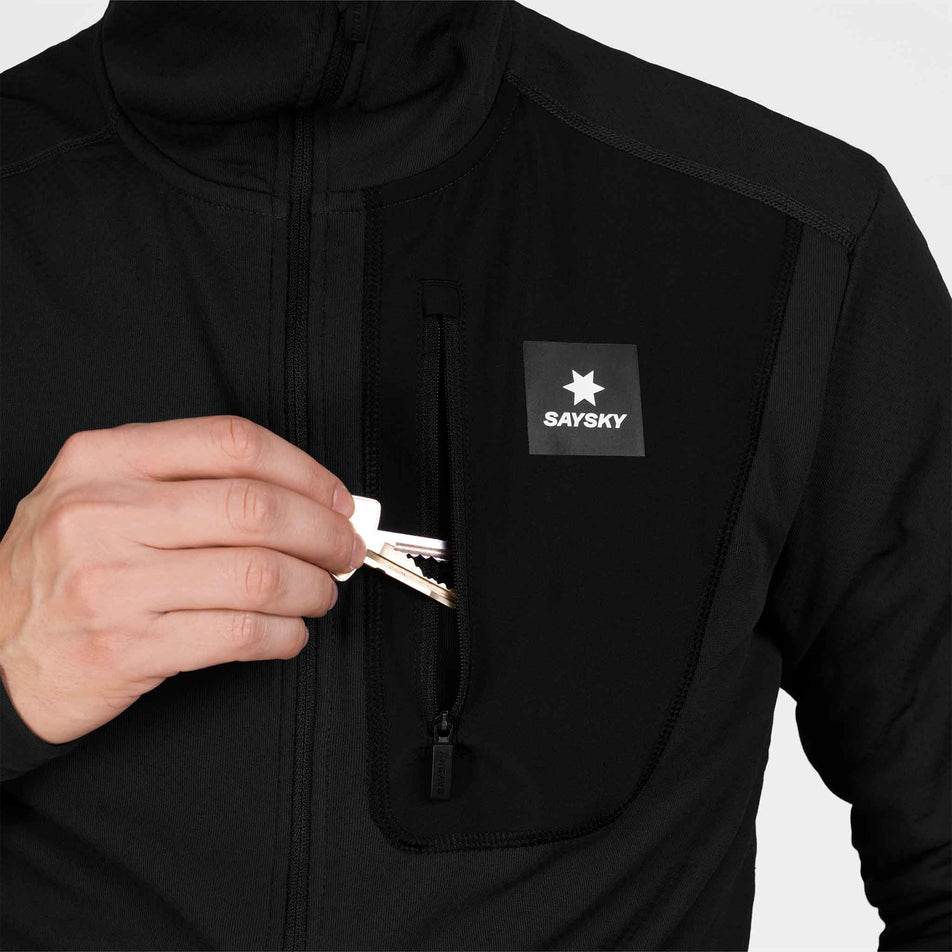 The chest zip pocket on the SAYSKY Men's Combat Half Zip Fleece Hoodie in the Black colourway.