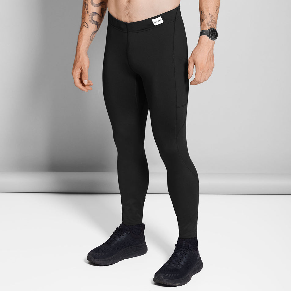 Front view of a model wearing the SAYSKY Men's Logo Motion+ Tights in the Black colourway.