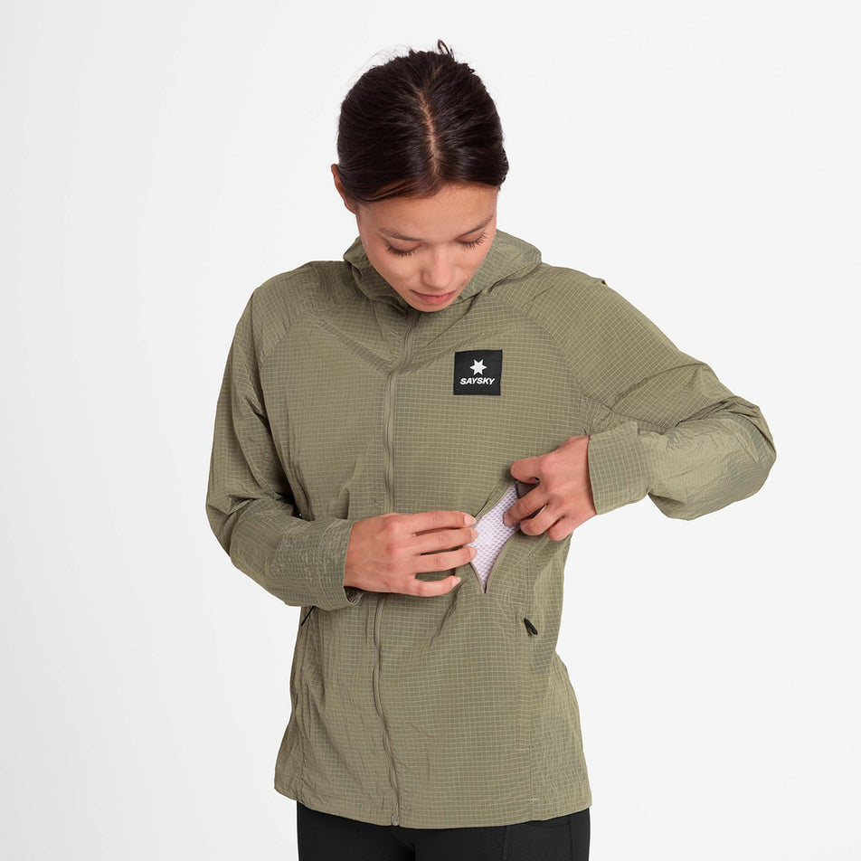 Front view of a model wearing the SAYSKY Women's Clean Pace Shield Jacket in the Beige colourway.