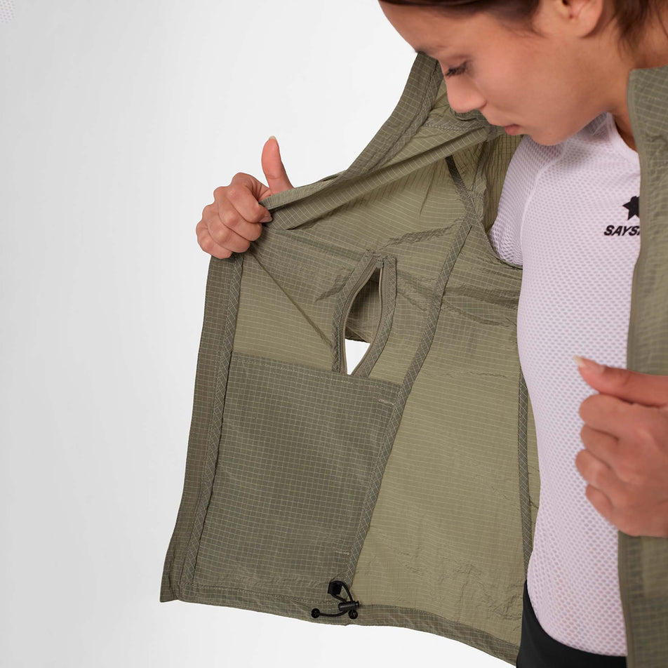 Front view of a model wearing the SAYSKY Women's Clean Pace Shield Jacket in the Beige colourway.