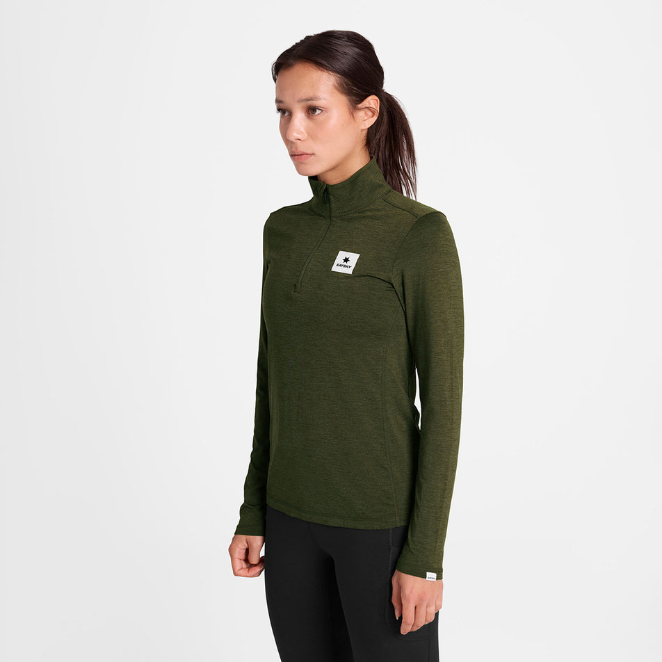 Front view of a model wearing the SAYSKY Women's Pace 1/2 Zip Long Sleeve in the Green colourway.