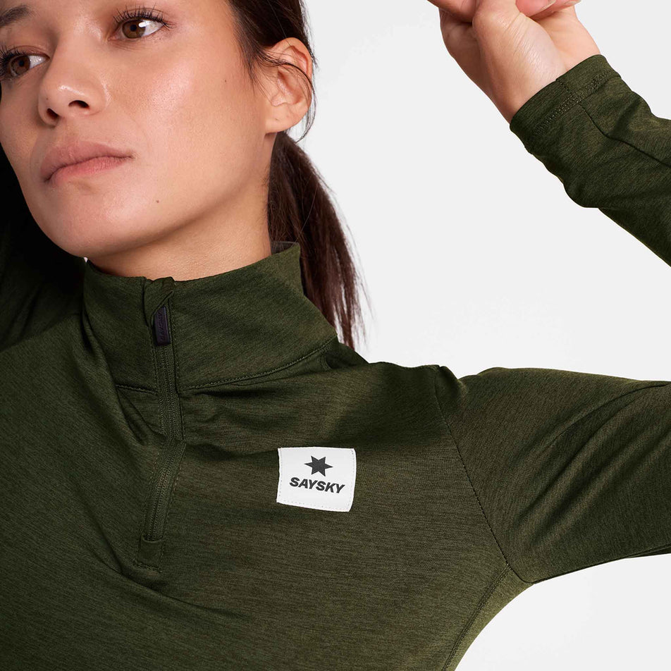 Front view of a model wearing the SAYSKY Women's Pace 1/2 Zip Long Sleeve in the Green colourway.