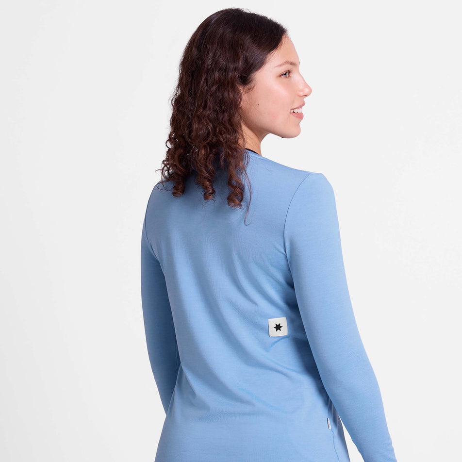 Back view of a model wearing the SAYSKY Women's Clean Pace Long Sleeve in the Blue colourway.
