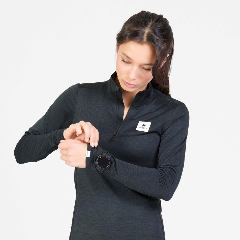 Front view of a model wearing the SAYSKY Women's Tiger Pace Half Zip Long Sleeve in the Black colourway.