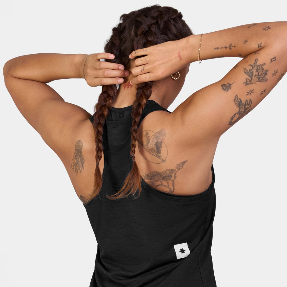 Back view of a model wearing the SAYSKY Women's Clean Combat Pro Singlet in the Black colourway.