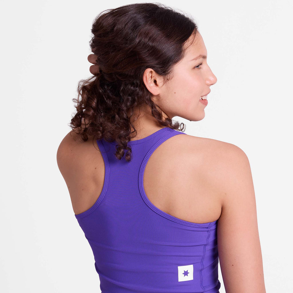 Back view of a model wearing the SAYSKY Women's Combat Rib Crop Top in the Purple colourway.