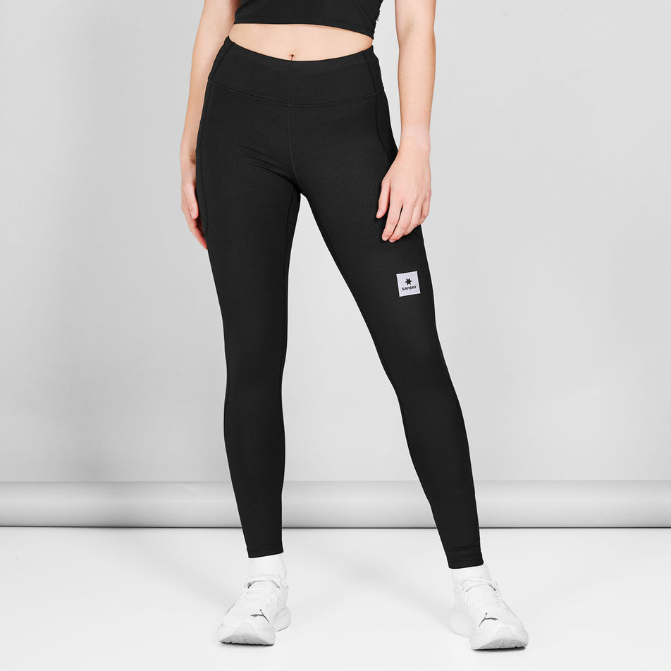 Front view of a model wearing the SAYSKY Women's Pace+ Long Tights in the Black colourway.