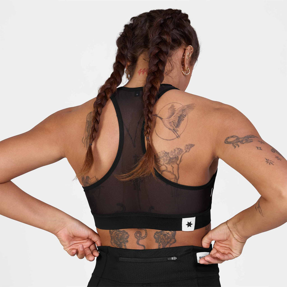 Back view of a model wearing the SAYSKY Women's Clean Combat Sports Bra in the Black colourway.