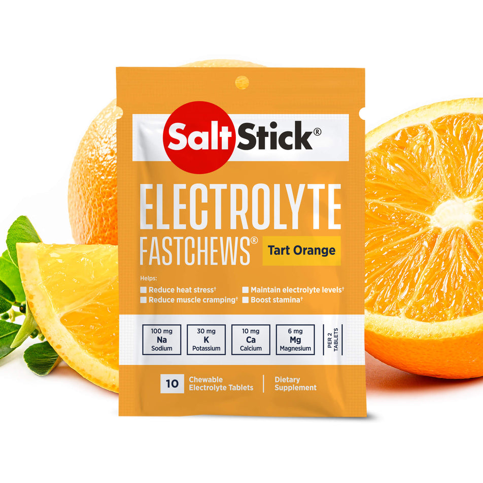 A packet of SaltStick Fast Chews in the Tart Orange flavour; with images of oranges in the background, behind the packet.  (8218222493858)