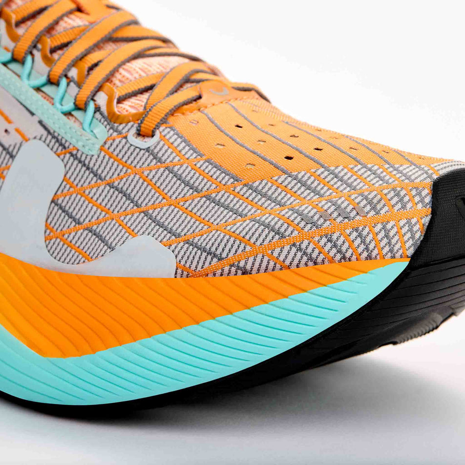 The toe box of the right shoe from a pair of True Motion Men's U-Tech Solo 2 Running Shoes in the White/Tangelo/Aqua Splash colourway.
