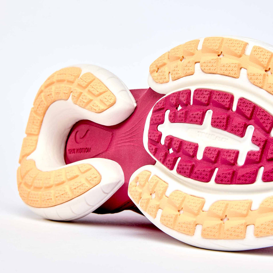 The outsole of the right shoe from a pair of True Motion Women's U-Tech Nevos 4 Running Shoes in the Sangria/Peach Fuzz/Anemone colourway.