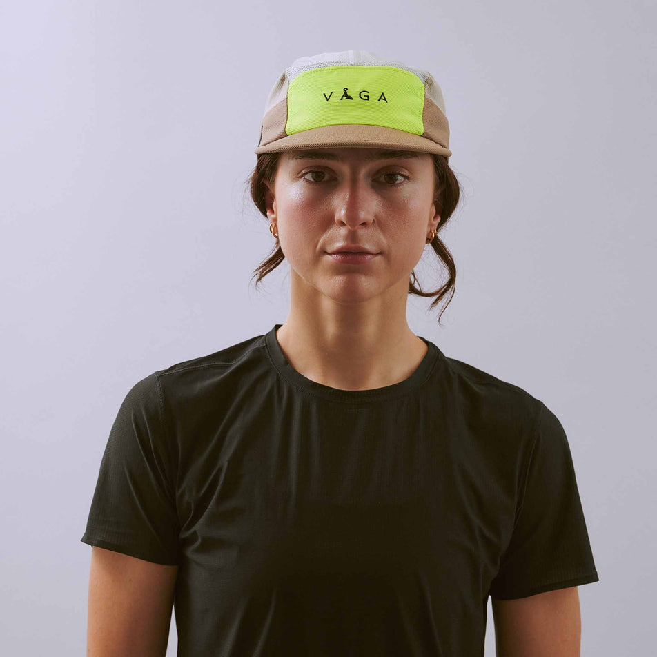Front view of a model wearing the VÅGA Unisex Club Cap in the Taupe/Neon Yellow/Light Grey colourway.