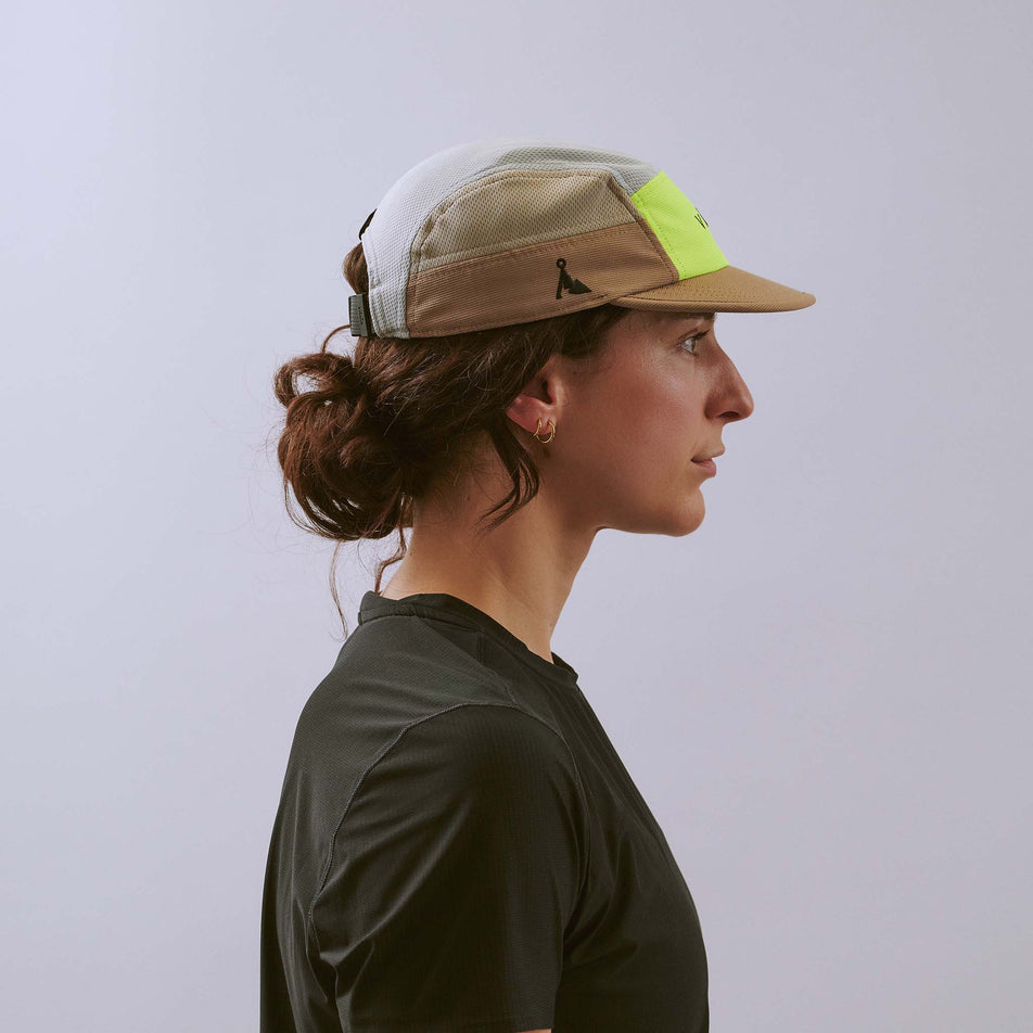 Side view of a model wearing the VÅGA Unisex Club Cap in the Taupe/Neon Yellow/Light Grey colourway.