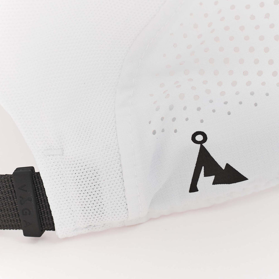 Close-up of a VAGA logo on the outer back-right side of a VAGA Unisex Feather Racing Cap in the White/Mist Grey/Black colourway (8217277759650)