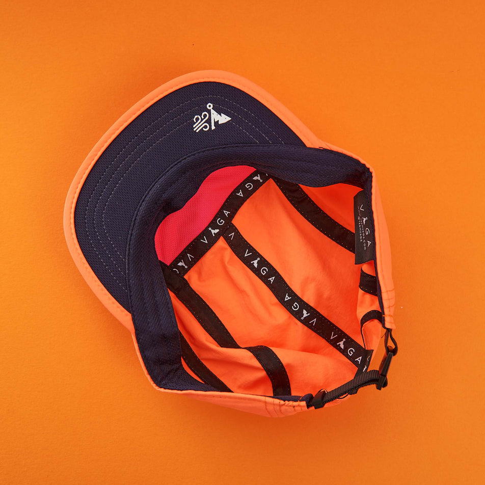 The inside of a VAGA Unisex Fell Cap in the Neon Orange/Navy colourway (8217265307810)
