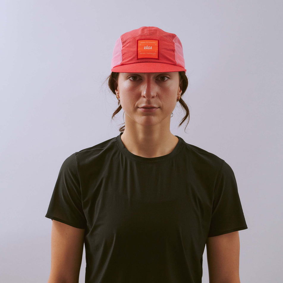 Front view of a model wearing the VÅGA Unisex Mesh Flex Cap in the Dark Pink/Pink colourway.