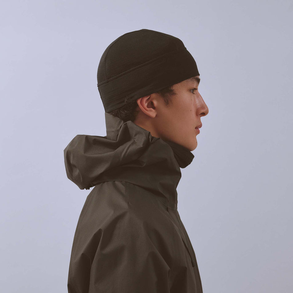 Side view of a model wearing the VAGA Unisex Summit Performance Skull Cap in the Black colourway.