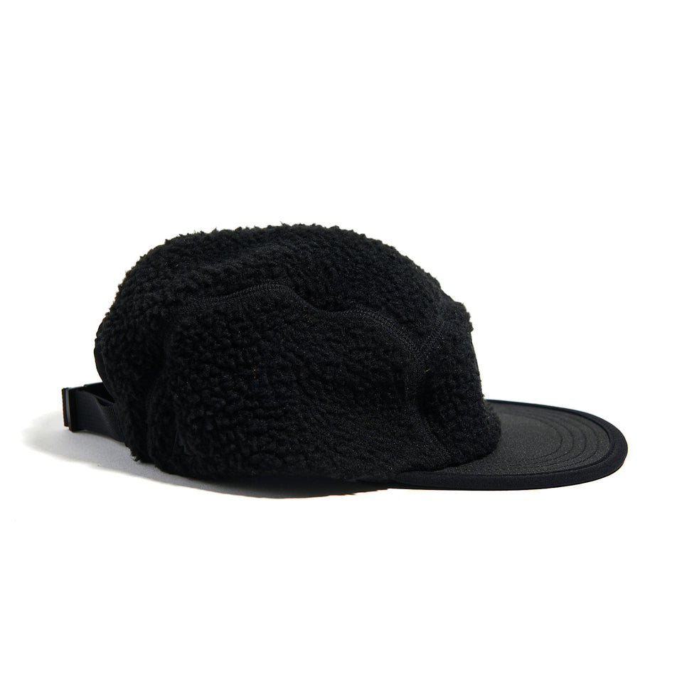 Side view of the VAGA Unisex Teddy Fleece Cap in the Black colourway. (8751586738338)