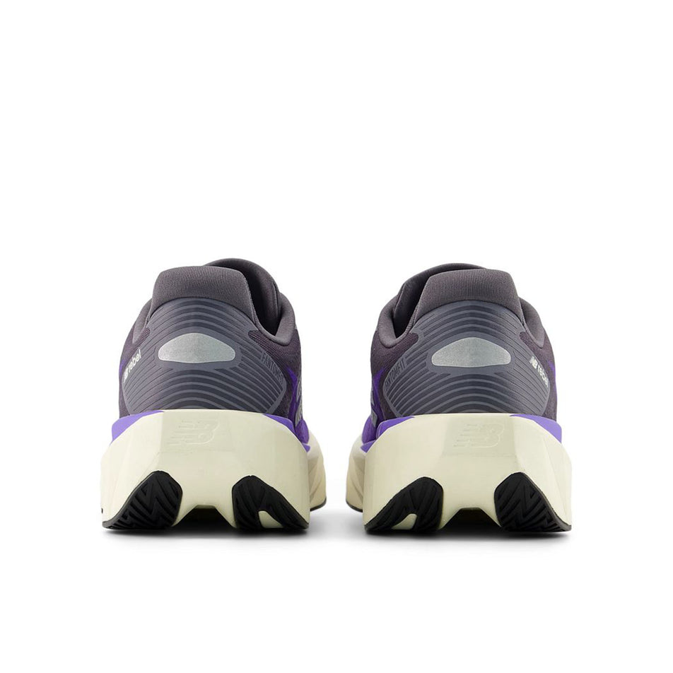 The back of a pair of New Balance Women's Fuelcell Rebel V5 Running Shoes in the Electric Indigo/Truffle Salt colourway.