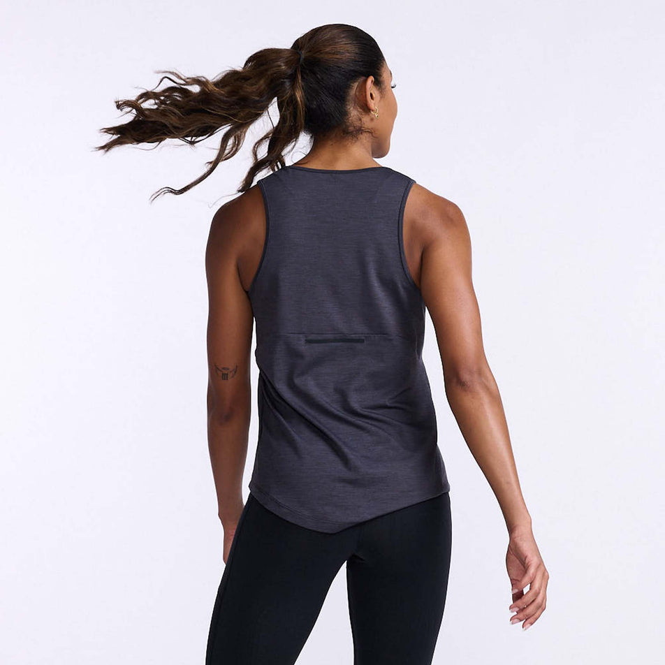Back view of a model wearing a 2XU Women's Motion Tank in the India Ink/Black colourway. Model is also wearing leggings. (8108362268834)