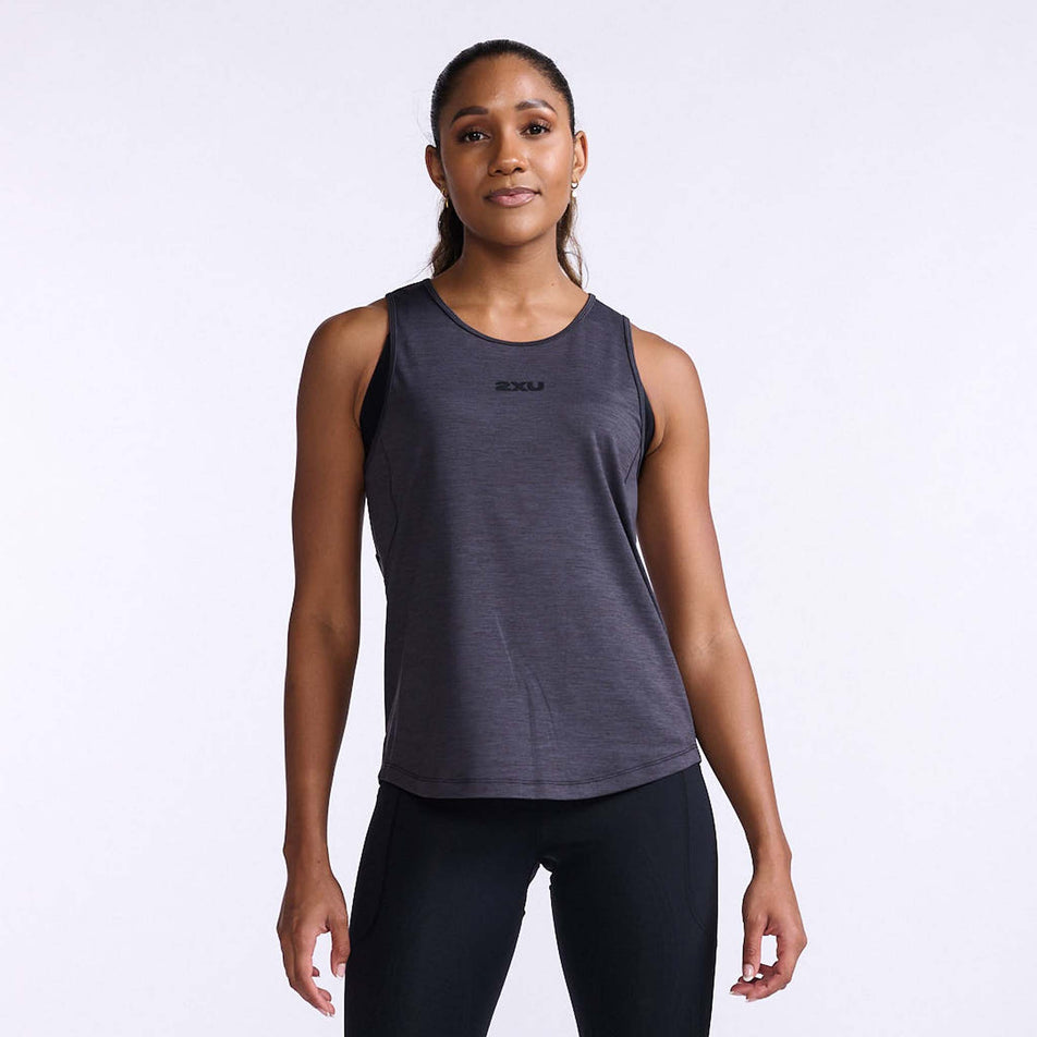 Front view of a model wearing a 2XU Women's Motion Tank in the India Ink/Black colourway. Model is also wearing leggings. (8108362268834)