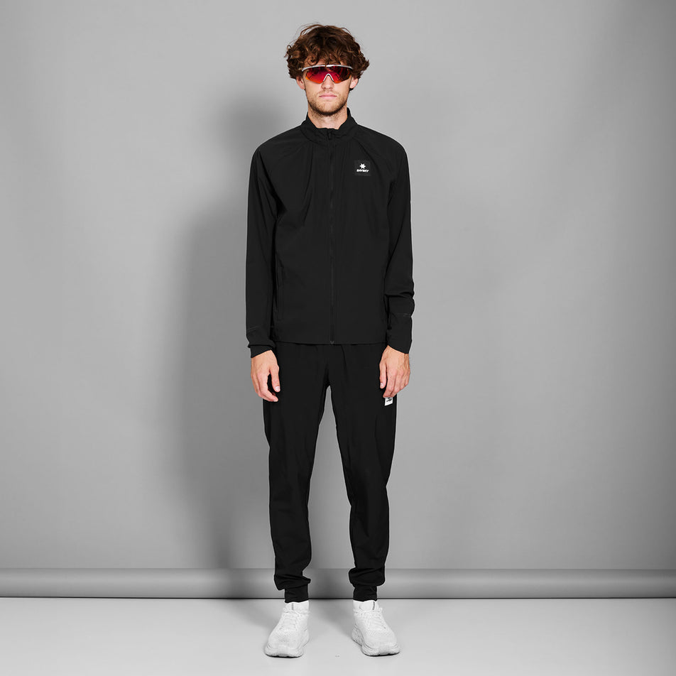 Front view of a model wearing the SAYSKY Men's Clean Pace Flex Jacket in the Black colourway. (8731609825442)