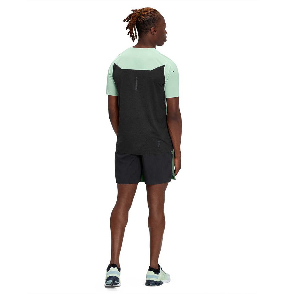 Back view of a model wearing a men's On Performance T in the Creek and Black colour (7763900924066)