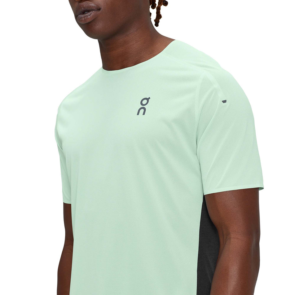 Close-up front view of a model wearing a men's On Performance T in the Creek and Black colour (7763900924066)